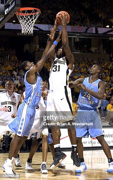 Wake Forest center Eric Williams goes up strong to the basket betwen North Carolina guard Jackie Manuel and forward Marvin Williams . Wake Forest...
