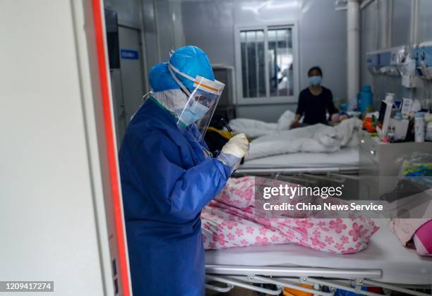 Medical worker examines a patient at the Huoshenshan makeshift hospital on February 22, 2020 in Wuhan, Hubei Province of China.