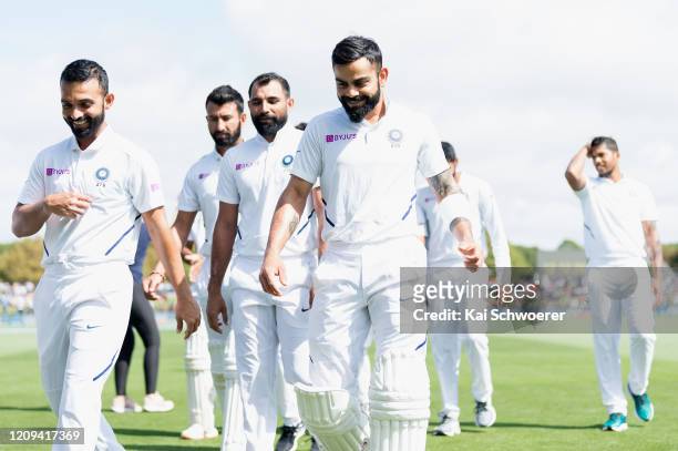 Captain Virat Kohli of India and his team mates look on during day one of the Second Test match between New Zealand and India at Hagley Oval on...