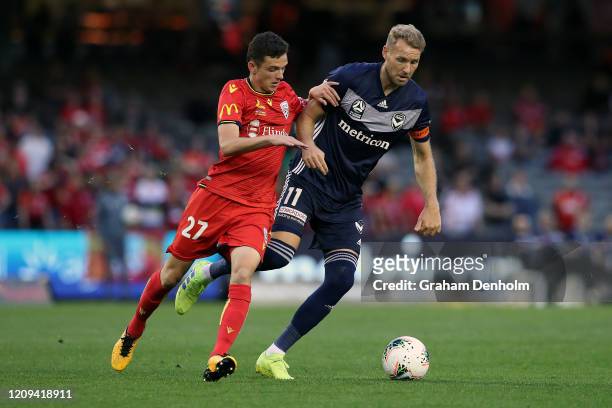Ola Toivonen of the Victory is challenged for the ball by Louis D'Arrigo of Adelaide United during the round 21 A-League match between the Melbourne...