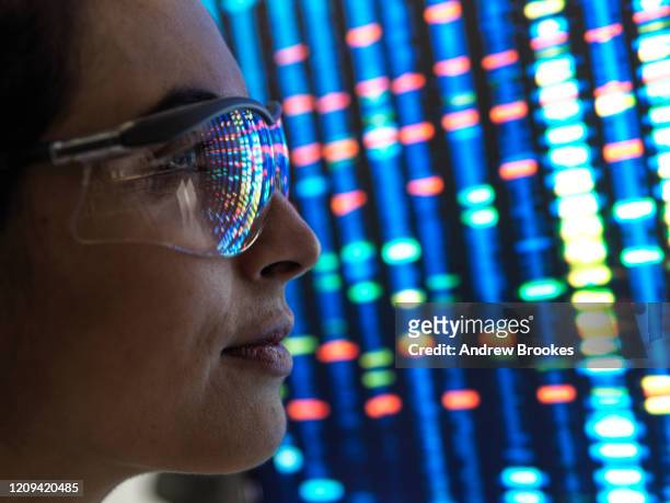 genetic research, female scientist viewing a dna profile of a human sample on a screen in the lab. - lab closeups stock-fotos und bilder