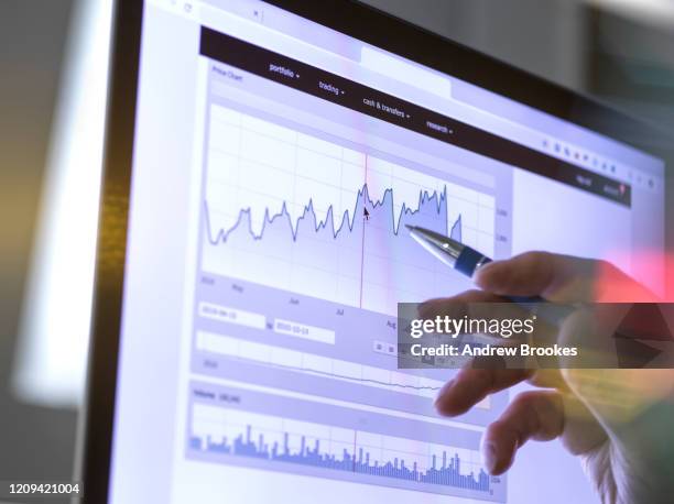 stock broker analyzing the performance of a company stock on the internet. - growing money stock pictures, royalty-free photos & images