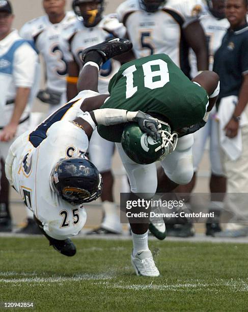 Freshman tight end Dwayne Holmes nearly gets his helmet ripped off by Kent State linebacker Cedric Davis Jehuu Caulcrick rushed for 140 yards and...