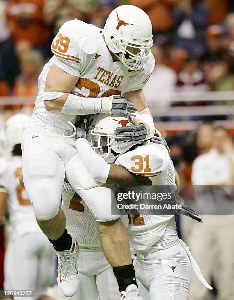 University of Texas players Brian Robison and Aaron Ross celebrate during the 2006 Alamo Bowl football game between the University of Texas Longhorns...