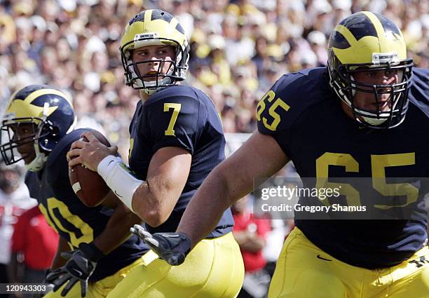 University of Michigans Chad Henne gets protection from Mike Hart and Leo Henige during first quarter action against Northern Illinois at Michigan...