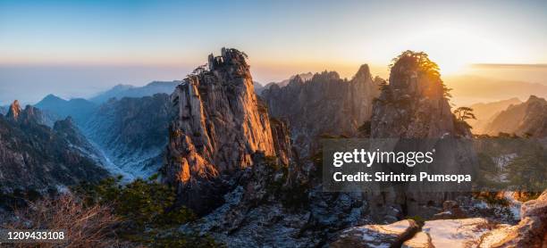 panorama scenery of huangshan mountain during sunrise in the winter season, anhui province, china - huangshan stock-fotos und bilder