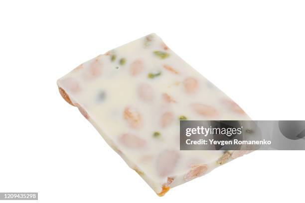 white chocolate with almonds and pistachios isolated on white background - caramel block stock pictures, royalty-free photos & images