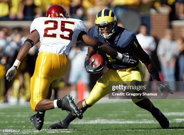 University of Michigans Braylon Edwards puts a move on Minnesota's Ukee Dozier during fourth quarter action at Michigan Stadium on October 9, 2004....