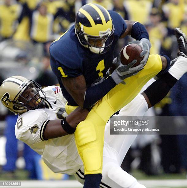 University of Michigan WR Braylon Edwards brings down a touchdown catch against Purdue CB Jacques Reeves during first quarter action at Michigan...
