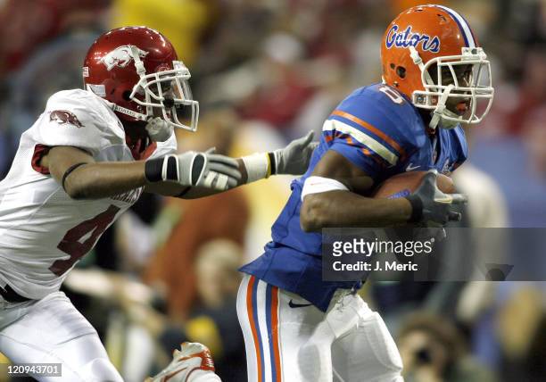 Florida's Percy Harvin is on the receiving end of a Chris Leak pass as Arkansas corner Darius Vinnett is late on the coverage during Saturday's SEC...