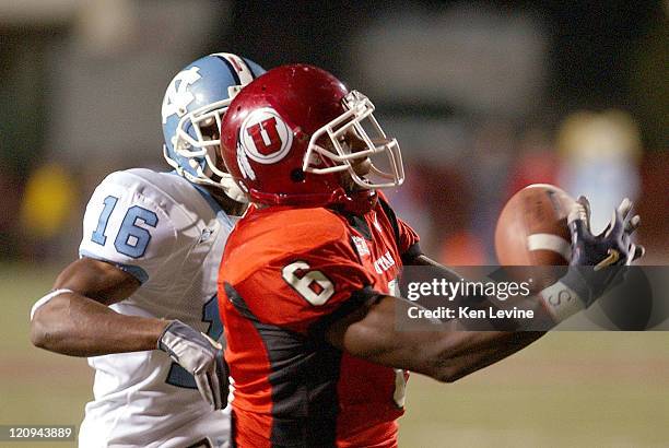 Utah receiver Steve Savoy catches a 46 yard touchdown pass thrown by Alex Smith during the second quarter as North Carolina defender Jacoby Watkins...