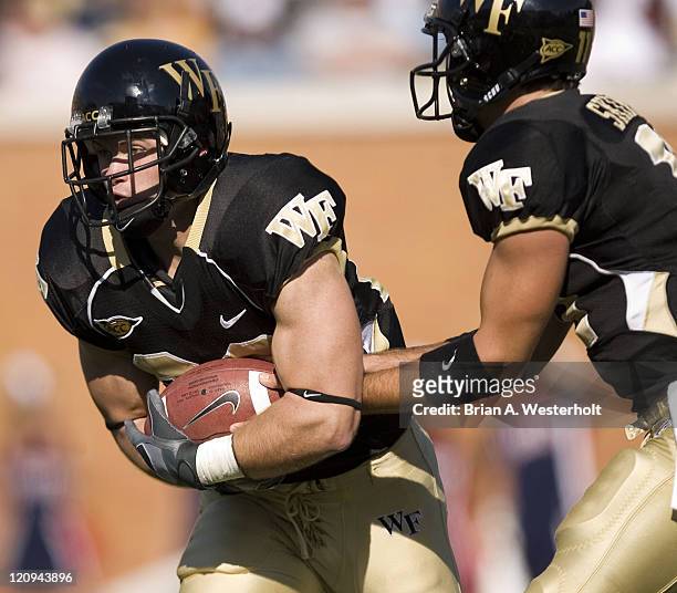 Wake Forest running back Kevin Harris takes a hand off from quarterback Riley Skinner during first half action versus the Liberty Flames at Groves...