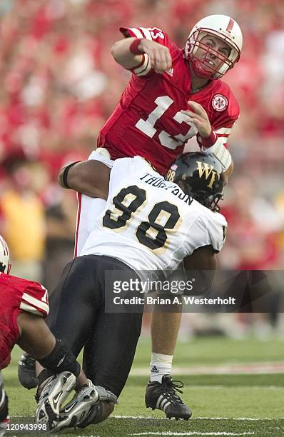 Nebraska QB Zac Taylor is hit by Wake Forest DE Jeremy Thompson just after releasing a pass during first quarter action at Memorial Stadium in...