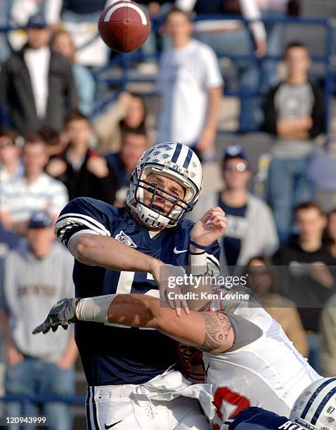 Quarterback John Beck just gets the pass away as New Mexico defensive lineman Wesley Beck applies the hit to Beck during the second quarter at LaVell...