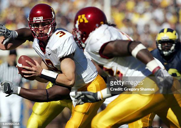 Minnesota's Bryan Cupito prepares to hand off to teammate Laurence Maroney during fourth quarter action against Michigan at Michigan Stadium on...