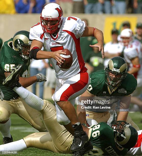 Miami quarterback Ben Roethlisberger eludes the tackles of Colorado States' Terence Carter Bryan Save and Drew Wood during the third quarter,Saturday...