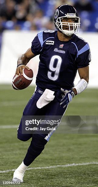 Toronto QB Damon Allen scrambles out of the pocket and looks for a receiver downfield in CFL action at Rogers Centre in Toronto Ontario Canada on...