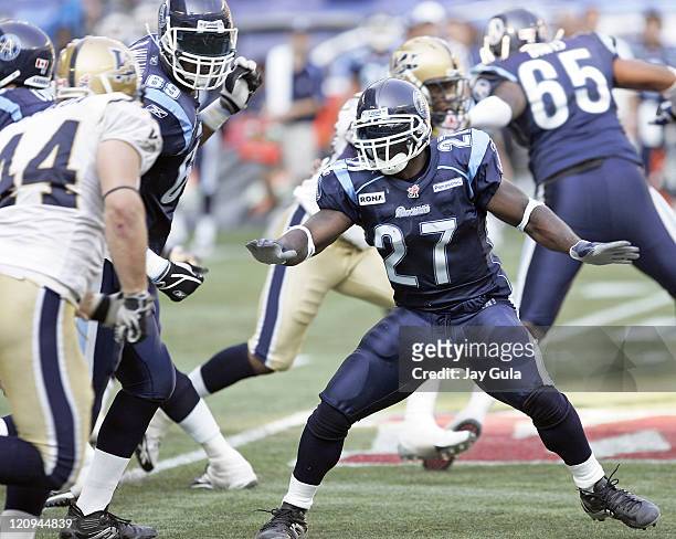 Ricky Williams of the Toronto Argonauts on the sidelines and in action vs the Winnipeg Blue Bombers in a Canadian Football League game at Rogers...