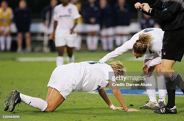 Penn State's Carmelina Moscato checks on injured teammate Allie Long during the 2005 NCAA Women's College Cup semifinal game between the Penn State...