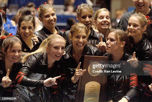 Courtney Kupets, center with trophy, is joined by her fellow Georgia teammates after they won the NCAA Women's Gymnastic title at the Huntsmann...