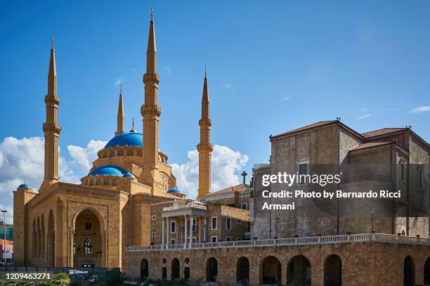 the st. george maronite cathedral close to the mohammad al-amin mosque - maronit stock pictures, royalty-free photos & images