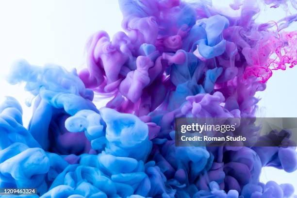 colorful ink swirling in water. - color explosion water stock pictures, royalty-free photos & images