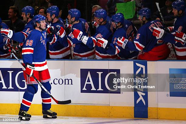 Jaromir Jagr of the New York Rangers is congratulated by his teammates on his goal in the first period against the Washington Capitals during the...