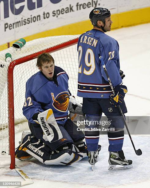 Atlanta Thrashers goalie Kari Lehtonen reacts to being pushed into the goal while forward Brad Larsen looks on during the game between the Atlanta...