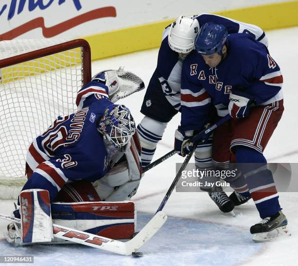New York Rangers goaltender Henrik Lundquist makes a save on Toronto Maple Leafs Mats Sundin as teammate Aaron Ward helps out in action at the Air...