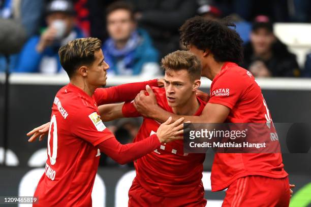 Joshua Kimmich of Bayern Munich celebrates with teammates Philippe Coutinho and Joshua Zirkzee after scoring his sides second goal during the...
