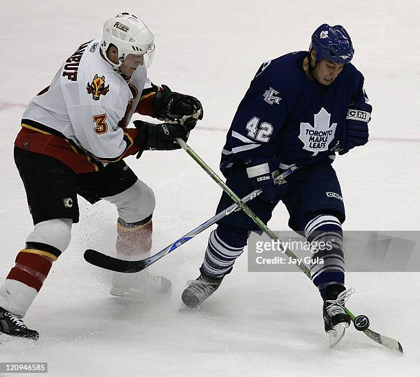 Toronto Maple Leaf forward Kyle Wellwood battles for the puck with Calgary defenceman Dion Phaneuf l in action at the Air Canada Centre in Toronto,...