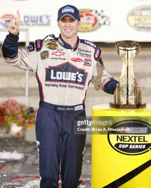 Jimmie Johnson poses with the trophy in Victory Lane after winning his second consecutive Coca-Cola 600 at Lowe's Motor Speedway, May 30, 2004.