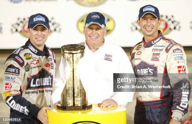 Jimmie Johnson, Team Owner Rick Hendrick and Crew Chief Chad Knauss pose with the trophy after winning the Coca-Cola 600 at Lowe's Motor Speedway,...