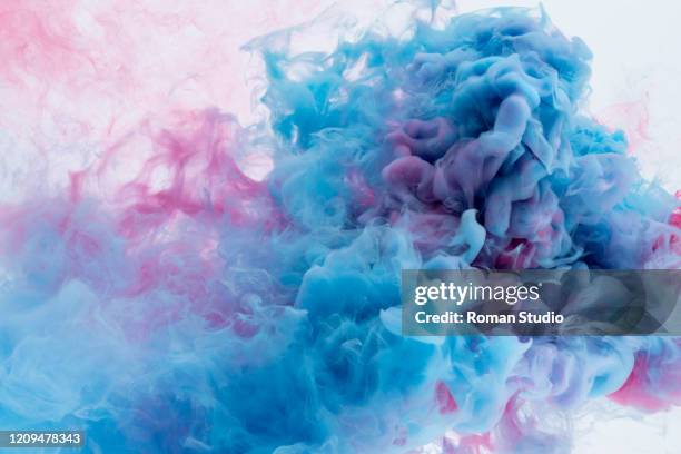 colorful ink swirling in water. - color explosion water stock-fotos und bilder