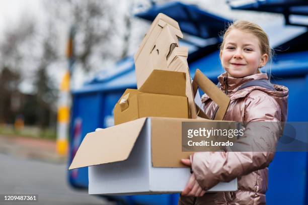 young girl at a paper recycling centre - recycling bins stock pictures, royalty-free photos & images