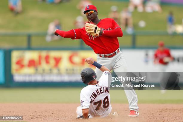 Didi Gregorius of the Philadelphia Phillies turns a double play against the Minnesota Twins in the fifth inning of a Grapefruit League spring...