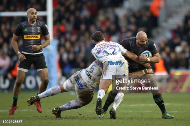 Paul Lasike of Harlequins is tackled by Dave Ewers and Tom Hendrickson of Exeter Chiefs during the Gallagher Premiership Rugby match between...