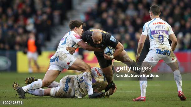 Paul Lasike of Harlequins is tackled by Dave Ewers and Tom Hendrickson of Exeter Chiefs during the Gallagher Premiership Rugby match between...