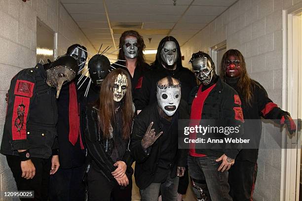 Chris Fehn, Paul Gray, Craig Jones, Joey Jordison, Jim Root, Corey Taylor, Mick Thomson, Sid Wilson and Shawn Crahan of Slipknot pose backstage at...