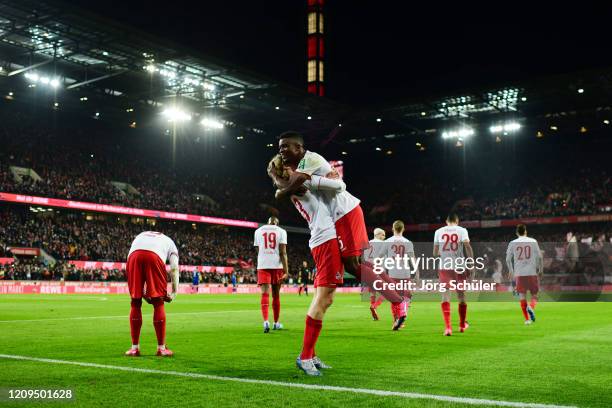 Jhon Cordoba of 1. FC Koeln celebrates with teammate Sebastiaan Bornauw after scoring his team's second goal during the Bundesliga match between 1....