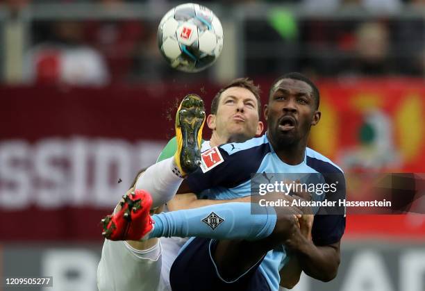 Stephan Lichtsteiner of Augsburg and Marcus Thuram of Borussia Monchengladbach battle for possession during the Bundesliga match between FC Augsburg...