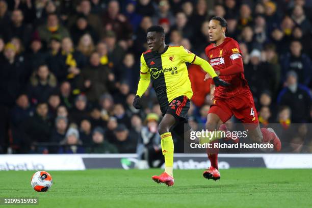 Ismaila Sarr of Watford breaks past Virgil van Dijk of Liverpool to score his team's second goal during the Premier League match between Watford FC...