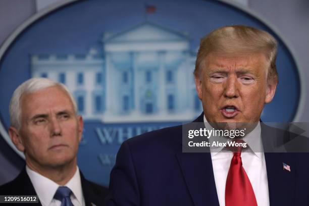 President Donald Trump speaks as Vice President Mike Pence looks on during a news conference at the James Brady Press Briefing Room at the White...