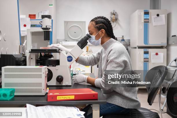 Raychel Lewis, cell culture technician, setting up equipment to test COVID-19 samples from recovered patients at Mirimus lab on April 8, 2020 in...