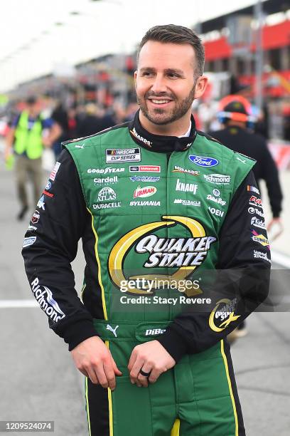 Matt DiBenedetto, driver of the Menards/Quaker State Ford, walks to his car during qualifying for the NASCAR Cup Series Auto Club 400 at Auto Club...