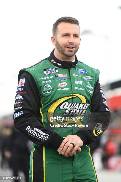 Matt DiBenedetto, driver of the Menards/Quaker State Ford, walks to his car during qualifying for the NASCAR Cup Series Auto Club 400 at Auto Club...