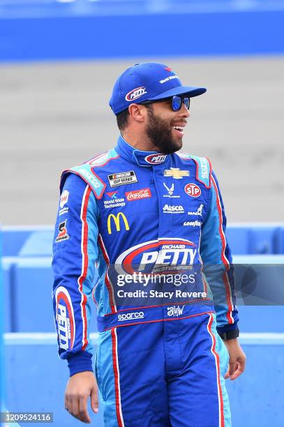 Bubba Wallace, driver of the Victory Junction Chevrolet, walks to his car during qualifying for the NASCAR Cup Series Auto Club 400 at Auto Club...