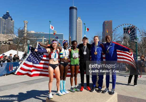 Molly Seidel, Aliphine Tuliamuk, Sally Kipyego, Jacob Riley, Galen Rupp, and Abdi Abdirahman pose together after finishing in the top three of the...