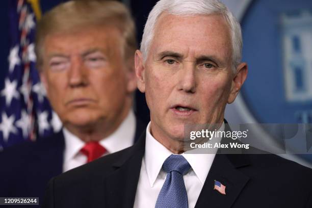 President Donald Trump listens as Vice President Mike Pence speaks during a news conference at the James Brady Press Briefing Room at the White House...