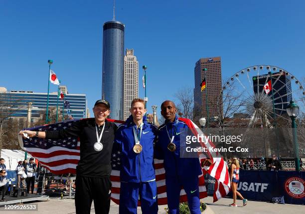 Jacob Riley, Galen Rupp, and Abdi Abdirahman pose together after finishing in the top three of the Men's U.S. Olympic marathon team trials on...
